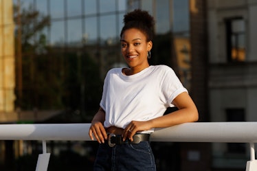 African girl in white T-shirt smiles in summer