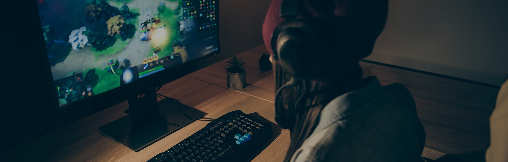 Back rear view photo of girlfriend playing video game with their friends speaking with them in front...