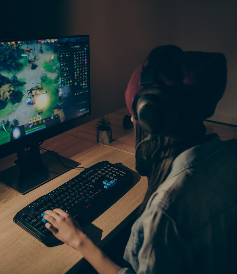 Back rear view photo of girlfriend playing video game with their friends speaking with them in front...