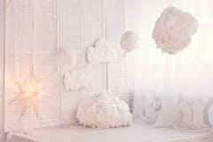 A room is decked out in fluffy clouds, fairy lights, and stars for a dreamy interior that looks like...