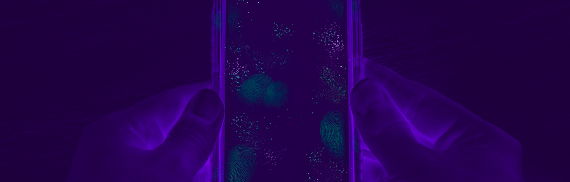 Hands holding cell phone with dirty contaminated touch screen - UV Blacklight exposing infectious ba...