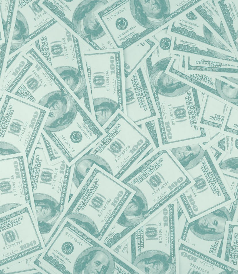 Group of money stack of 100 US dollars banknotes a lot of the background texture top view