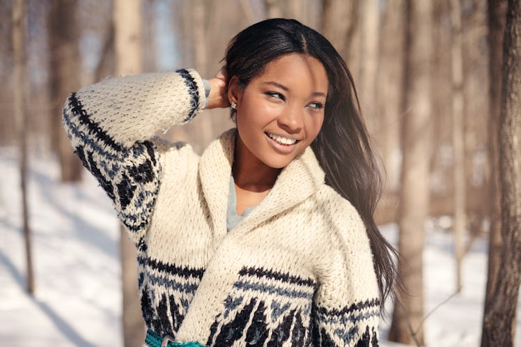 Beautiful young woman in the snow in winter