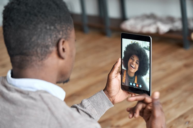 African american man video calling girlfriend on digital tablet. Black couple talking dating by virt...