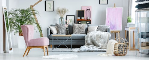 Cozy pastel room with vintage furniture, pink accents and armchair stylish interior
