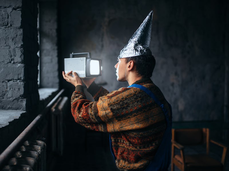 Paranoid man in tinfoil cap, mind protection, UFO