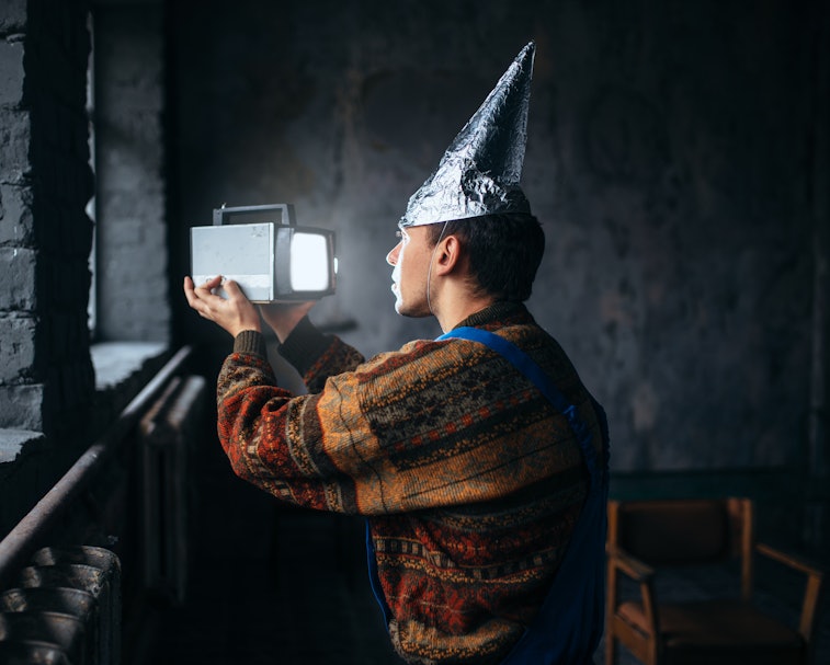 Paranoid man in tinfoil cap, mind protection, UFO