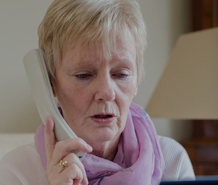 Senior Woman Giving Credit Card Details On The Phone