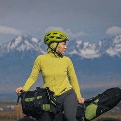 The woman travel on mixed terrain cycle touring with bikepacking. The traveler journey with bicycle ...