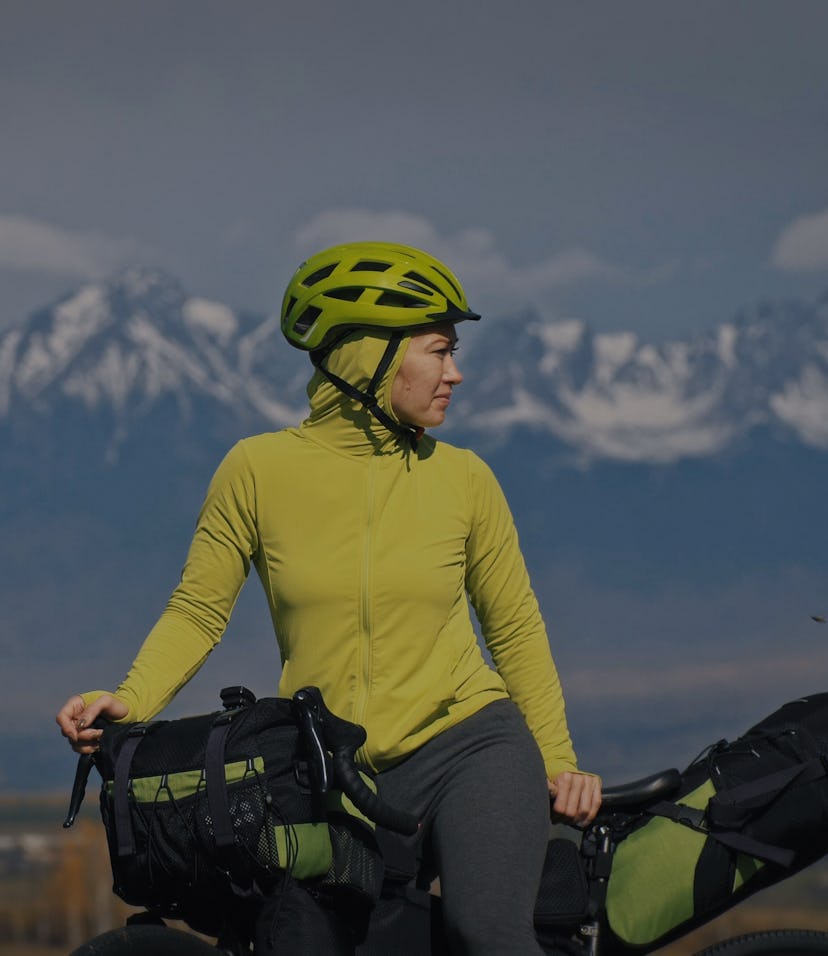 The woman travel on mixed terrain cycle touring with bikepacking. The traveler journey with bicycle ...