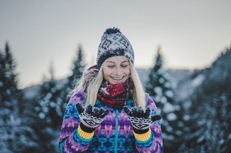 Young happy beautiful girl smiling and laughing in the snow, cozy and winter clothes, outdoor outfit...