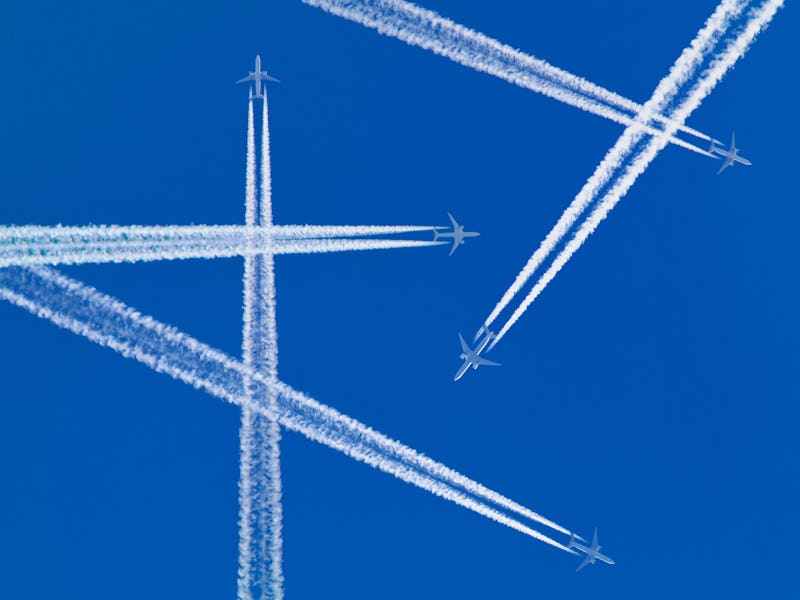 Several aircraft with white contrails