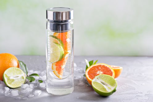 Infused water with orange and lime in a bottle