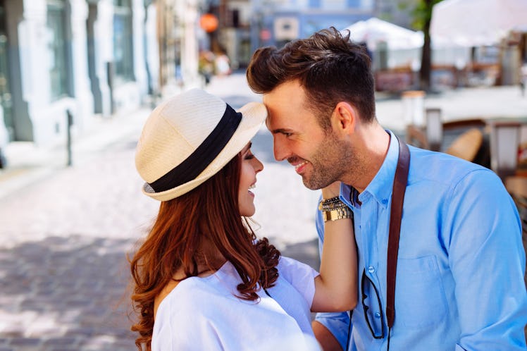 Couple hugging on city street during summer vacation