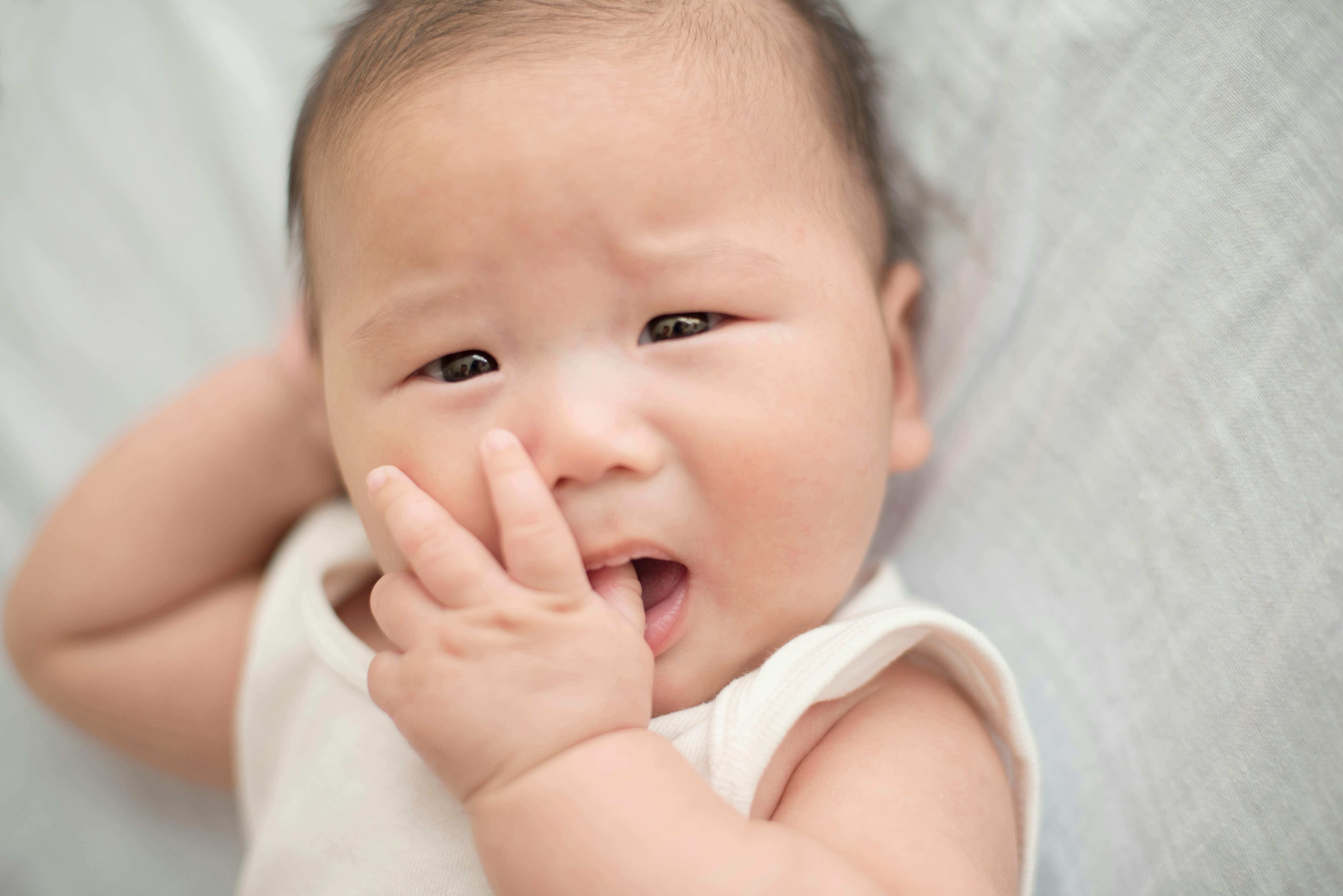 2 month old baby chewing store on nothing