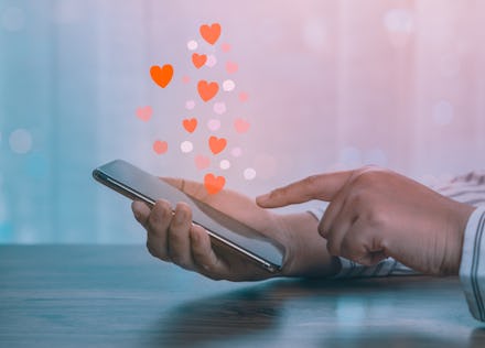 Woman hands using mobile smartphone with social love app for valentine's day.