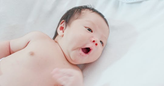 Newborn baby on bed