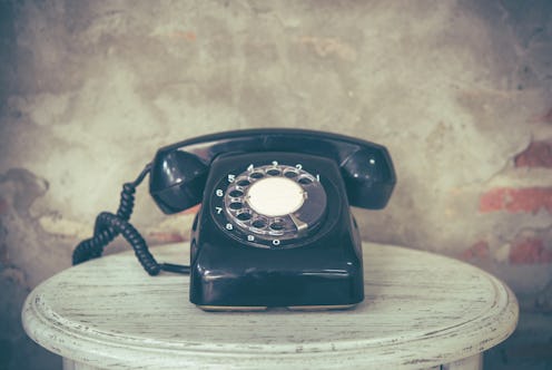 Old telephone with dust and scratches with vintage background, retro style concept