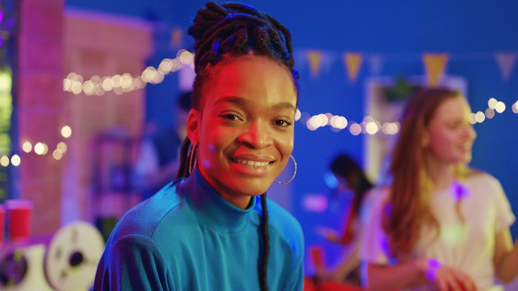 Lovely cheerful afro-american beautiful girl smiling happy at camera enjoying celebration socializin...