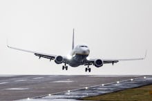 A Ryanair aircraft arriving from Gdansk struggles to land in strong winds at Leeds Bradford airport ...