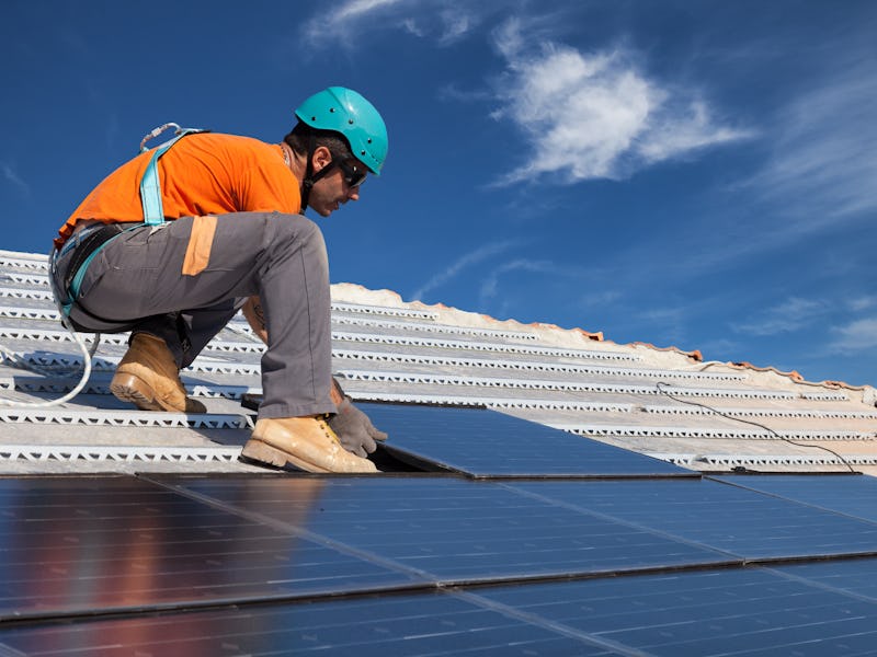 technician install new generation photovoltaic solar panels on roof