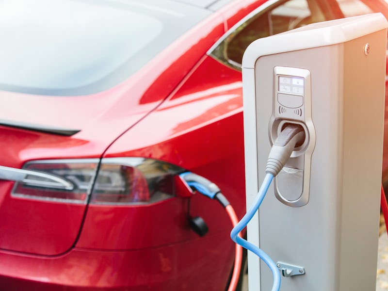 Charging modern electric car (new energy vehicles, NEV) on the street station