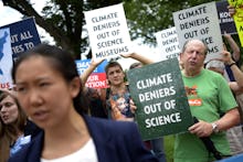 Protesters Chant in Front of the Smithsonian Castle During a Rally Against Board Member David Koch i...