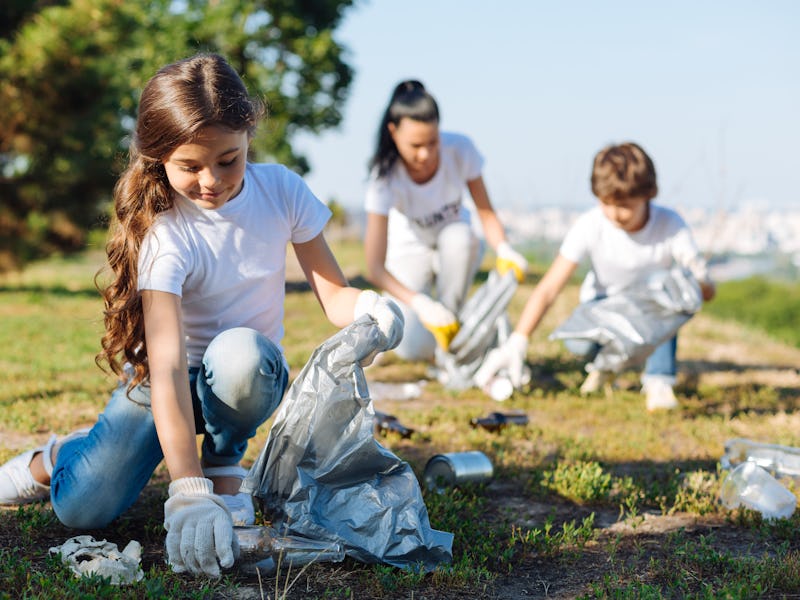 Delighted girl working in volunteer group