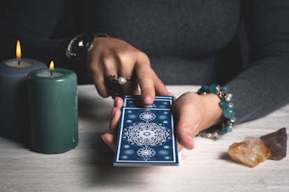 Tarot cards in fortune teller hands concept.