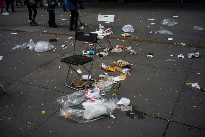 People walk by litter on the ground after the Macy's Thanksgiving Day Parade, in New York