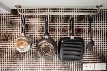 Pots and pans and ladle for cooking, hanging in the kitchen