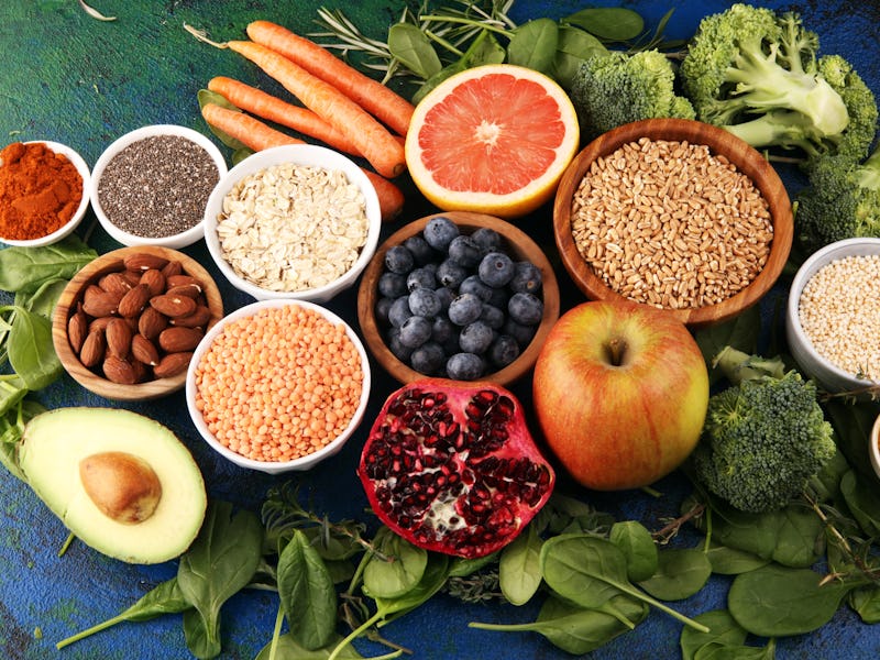 Healthy food clean eating selection: fruit, vegetable, seeds, superfood, cereals, leaf vegetable on ...