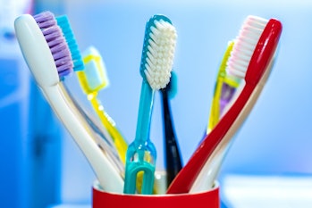 Toothbrushes stand in a glass
