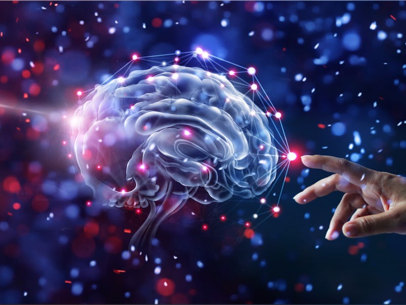 Hand touching brain and network connection on glitter bright lights colorful background