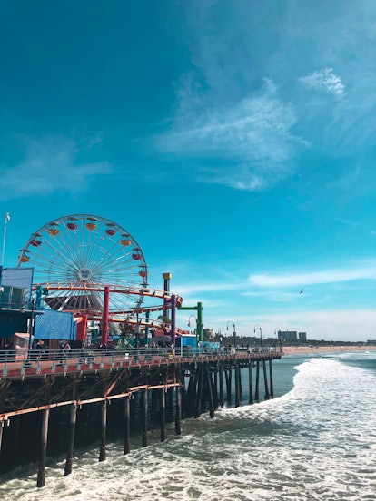 The Santa Monica Pier in California features a carousel, Ferris wheel, and lots of colorful rides on...