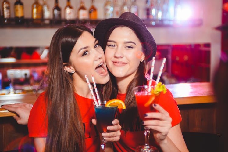 Two young girls lesbians at a party in the club. Valentine's Day