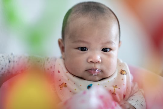 baby boy blowing spit bubbles