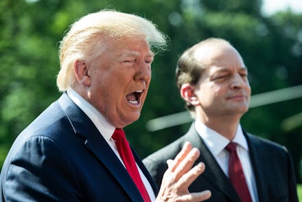 US President Donald Trump (L) delivers remarks to members of the news media beside US Labor Secretar...