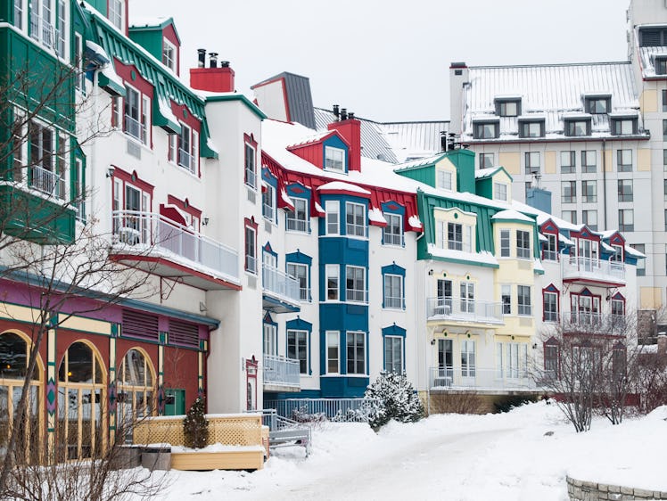 Snow covers colorful buildings in Mont Tremblant, Canada.