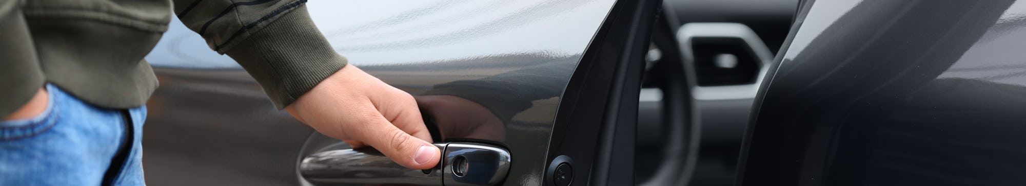 Closeup view of man opening car door