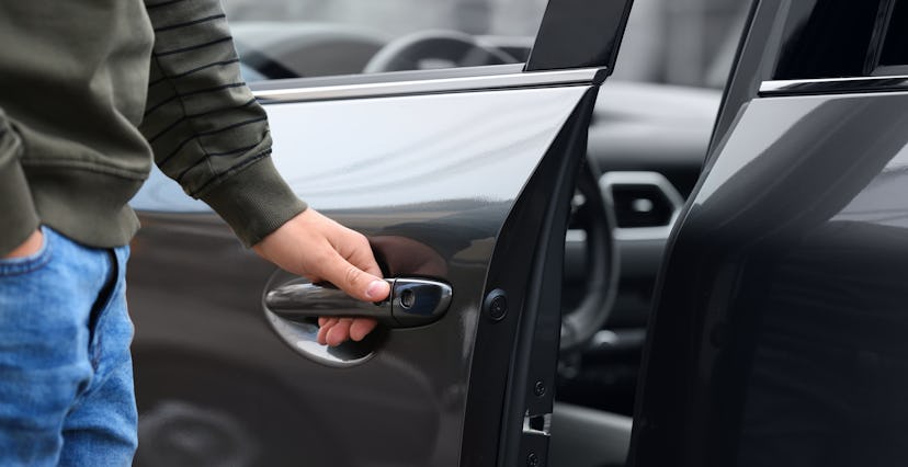 Closeup view of man opening car door