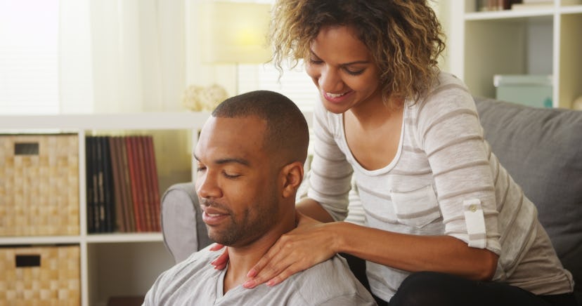 Black girlfriend giving boyfriend massage