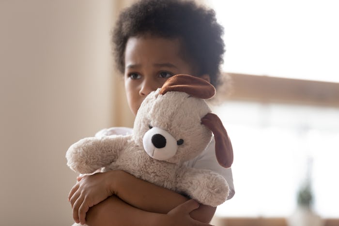 little boy holding a stuffed animal