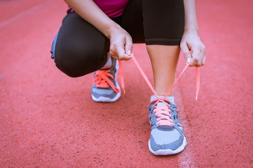 Athlete girl trying running shoes getting ready for jogging.