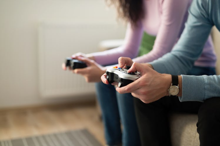 Young people playing video games on console controllers
