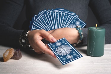 Tarot cards in fortune teller hands concept.