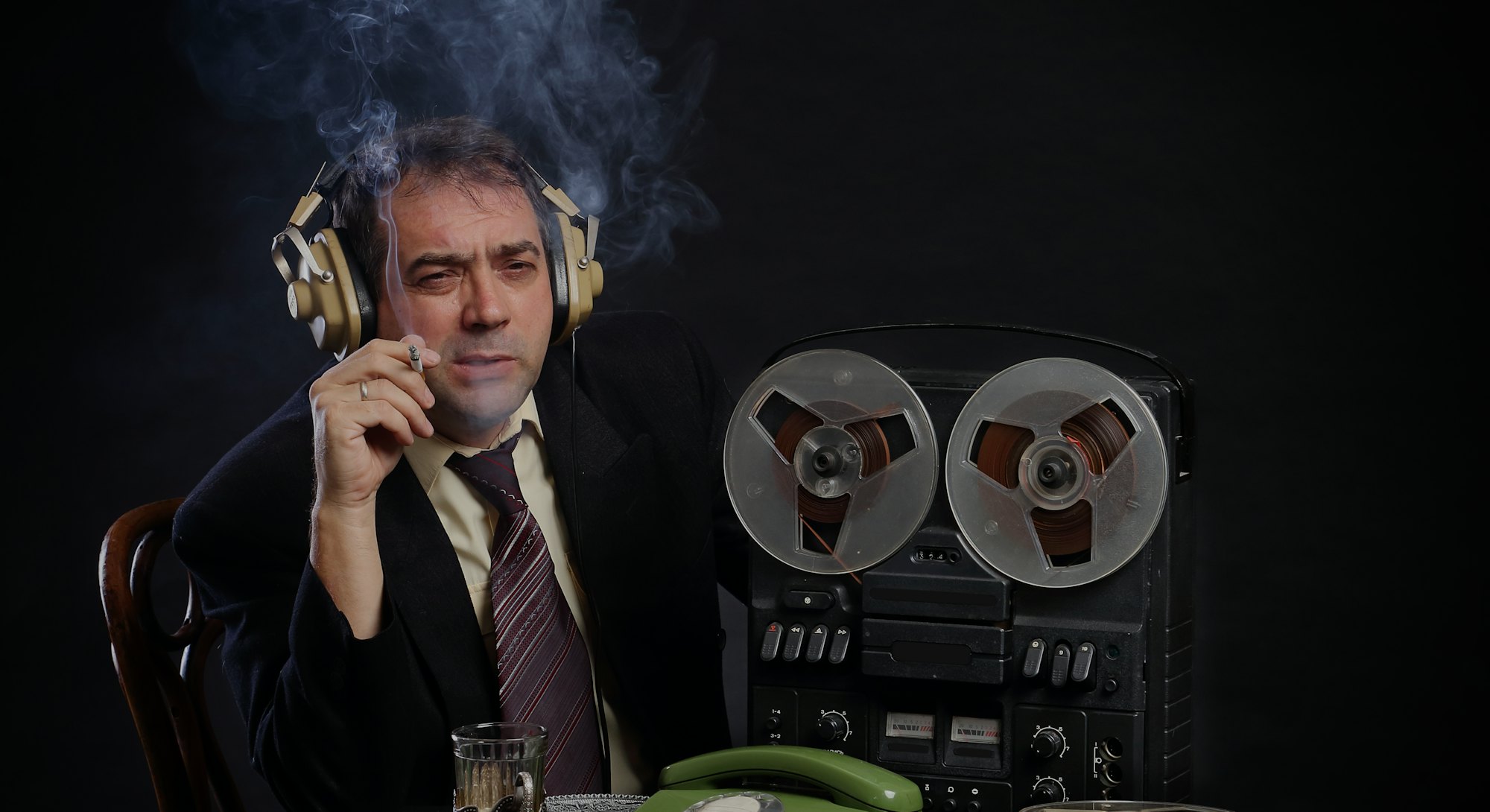 Man in headphones listen to music on record player