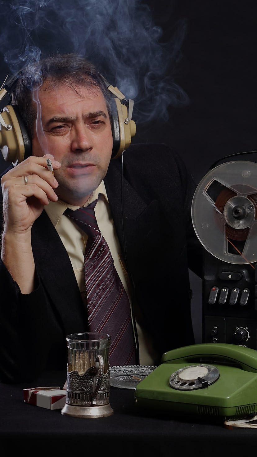 Man in headphones listen to music on record player