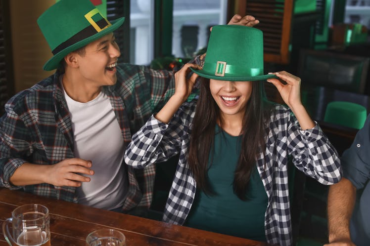 Young friends celebrating St. Patrick's Day in pub