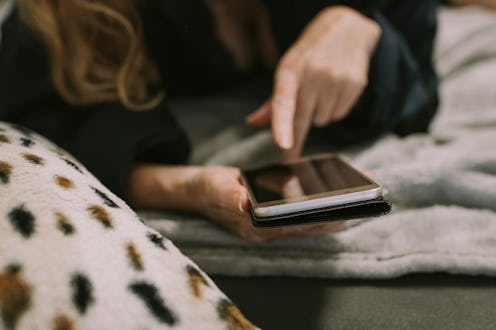 woman with cell phone in the room at home